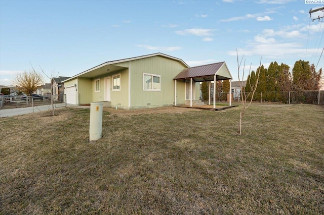 view of side of home featuring a garage, a fenced backyard, and a yard