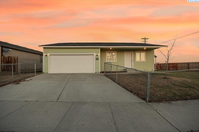 view of front facade with a fenced front yard, driveway, and an attached garage