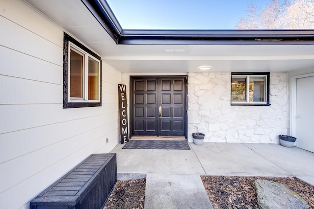 view of exterior entry featuring stone siding