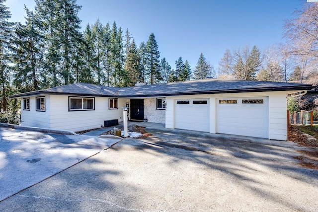 ranch-style home with driveway and an attached garage