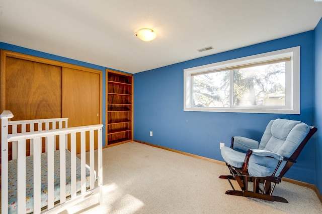 carpeted bedroom with visible vents and baseboards