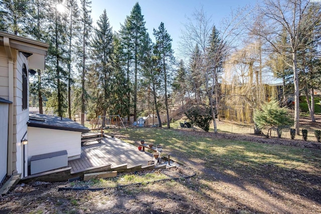 view of yard featuring a playground and a wooden deck