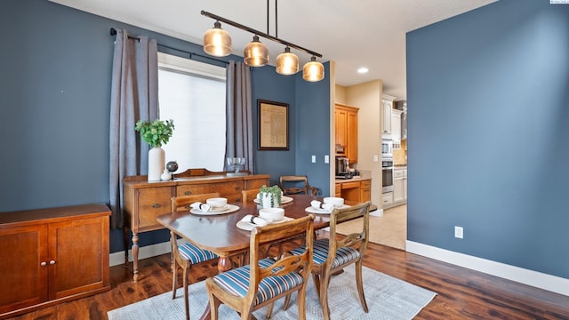 dining room with recessed lighting, baseboards, and dark wood finished floors