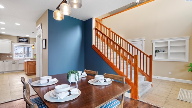 dining space featuring light tile patterned floors, stairway, baseboards, and recessed lighting