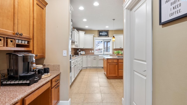 kitchen featuring light tile patterned flooring, recessed lighting, pendant lighting, white cabinetry, and tasteful backsplash