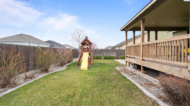 view of yard with a fenced backyard and a playground