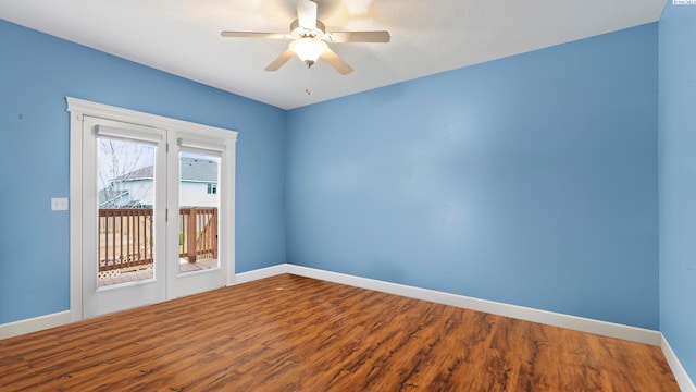 empty room with wood finished floors, baseboards, and ceiling fan