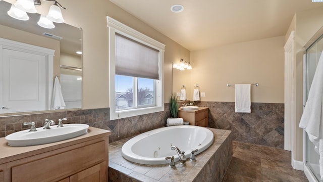 full bath with a shower stall, visible vents, a whirlpool tub, and a sink