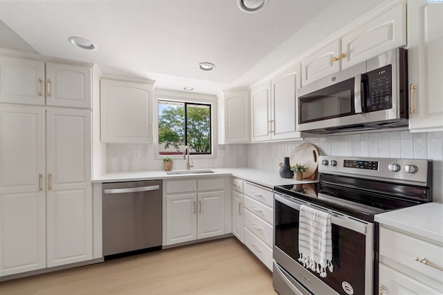 1819 Newport St, Kennewick, WA 99337 - kitchen with stainless steel appliances, a sink, white cabinetry, light countertops, and recessed lighting