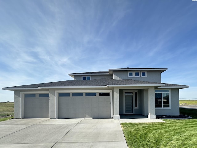 prairie-style house with a garage and a front yard