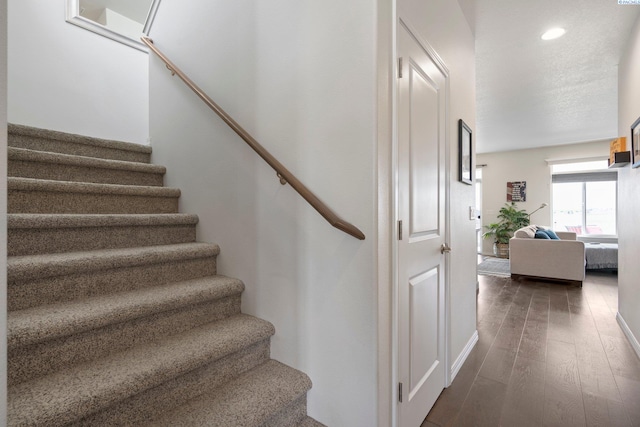 stairs featuring wood-type flooring