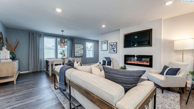 579 S Zeelar St, Kennewick, WA 99336 - living area featuring wood finished floors, a glass covered fireplace, recessed lighting, and a chandelier