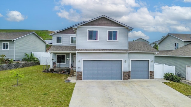 1025 SW Corral Ct, Pullman, WA 99163 - view of front of house with driveway, stone siding, a shingled roof, and a garage