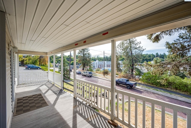 wooden terrace featuring covered porch