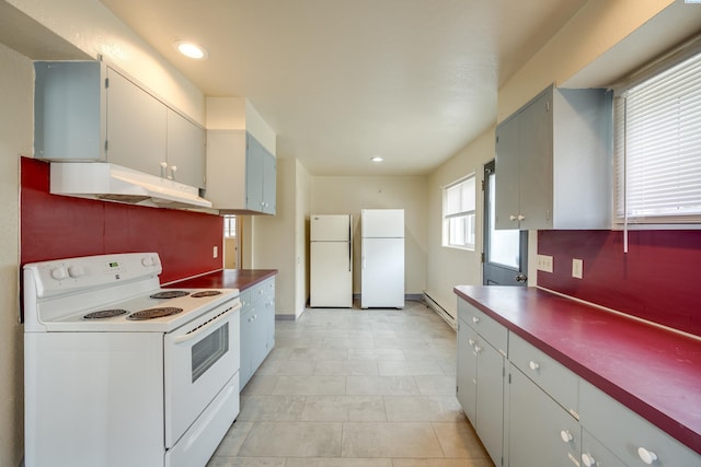 kitchen featuring light tile patterned floors and white appliances