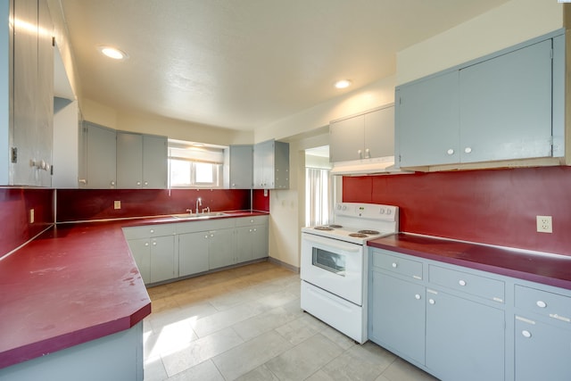 kitchen with sink, decorative backsplash, and electric stove