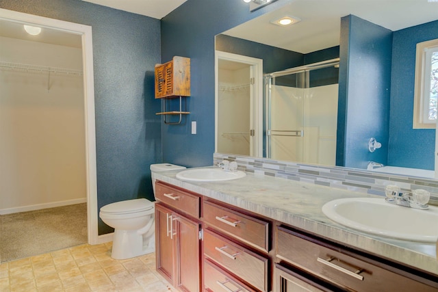 4210 Cornish Ln, Pasco, WA 99301 - full bath featuring a sink, tasteful backsplash, a spacious closet, and a shower stall