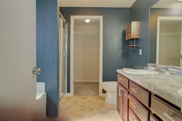 4210 Cornish Ln, Pasco, WA 99301 - full bathroom with double vanity, a sink, decorative backsplash, a shower stall, and toilet
