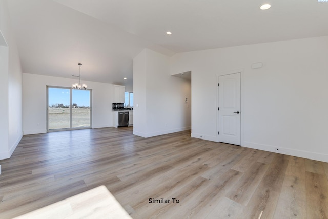 1610 Diamond Ave, Grandview, WA 98930 - unfurnished living room with vaulted ceiling, a chandelier, light wood-style flooring, and recessed lighting