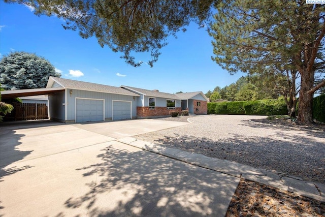10012 Maple Dr, Pasco, WA 99301 - ranch-style home featuring driveway, a garage, a carport, board and batten siding, and brick siding