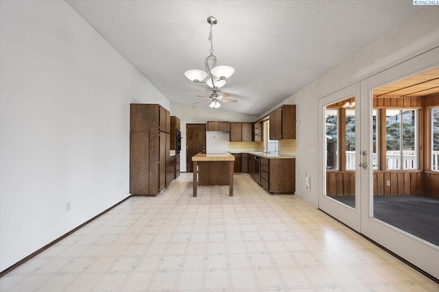 10012 Maple Dr, Pasco, WA 99301 - kitchen featuring a chandelier, light countertops, lofted ceiling, light floors, and a sink