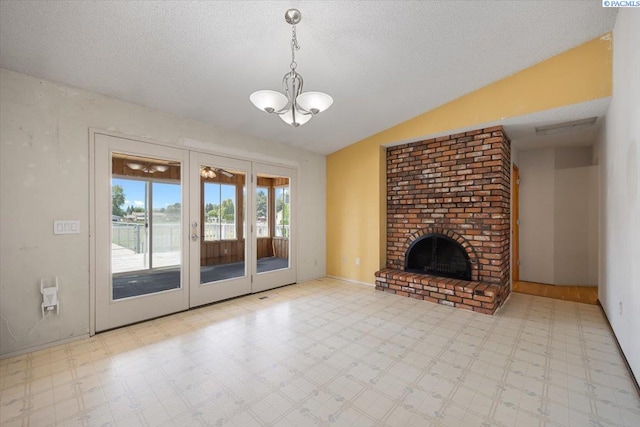 10012 Maple Dr, Pasco, WA 99301 - unfurnished living room featuring tile patterned floors, a chandelier, lofted ceiling, a textured ceiling, and a fireplace