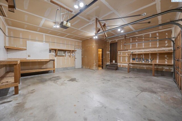 10012 Maple Dr, Pasco, WA 99301 - garage with a workshop area and a garage door opener