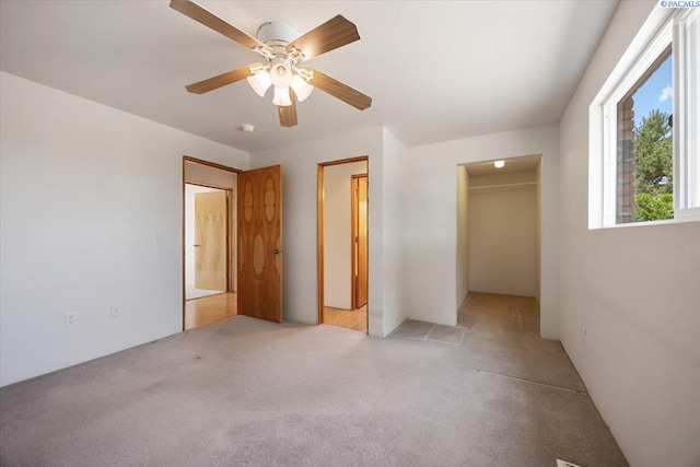 10012 Maple Dr, Pasco, WA 99301 - unfurnished bedroom featuring light carpet, a walk in closet, a closet, and a ceiling fan