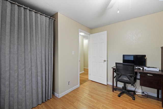 office space featuring wood-type flooring and ceiling fan