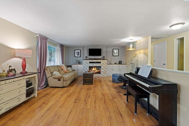 living room with a fireplace and light wood-type flooring