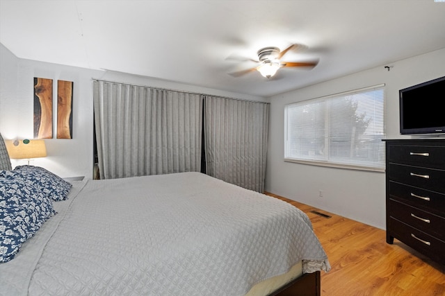 bedroom with light hardwood / wood-style floors and ceiling fan