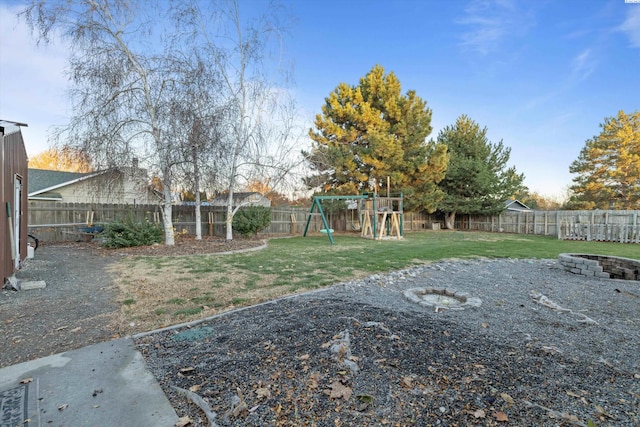 view of yard with a fire pit and a playground