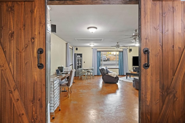 foyer entrance featuring ceiling fan and concrete floors