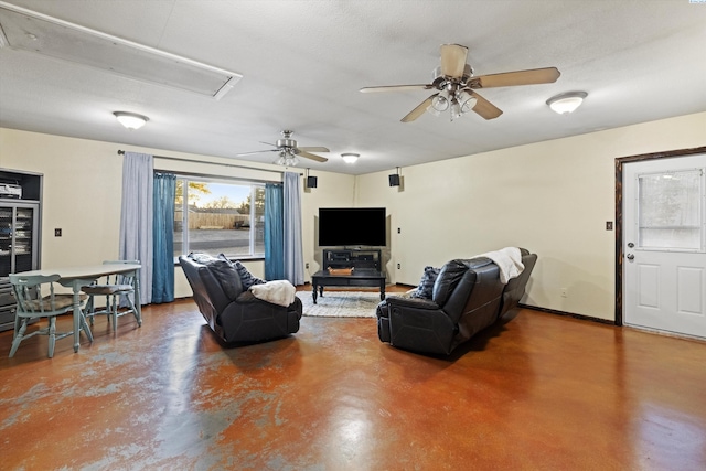 living room with ceiling fan and concrete flooring