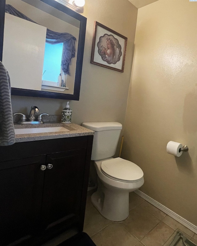 976 Campbell Dr, Prosser, WA 99350 - half bath with vanity, toilet, tile patterned floors, and baseboards