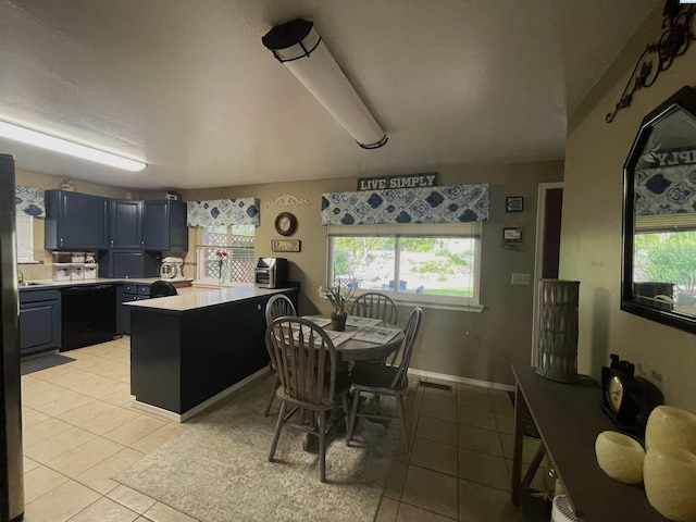 976 Campbell Dr, Prosser, WA 99350 - kitchen with light tile patterned floors, light countertops, plenty of natural light, and blue cabinetry