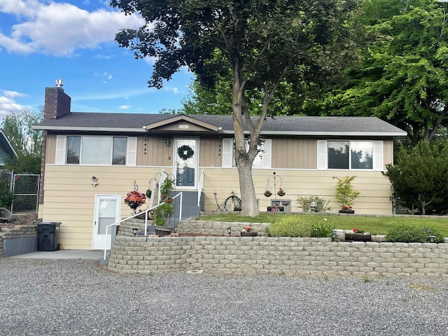 976 Campbell Dr, Prosser, WA 99350 - view of front of home with a chimney, board and batten siding, and roof with shingles