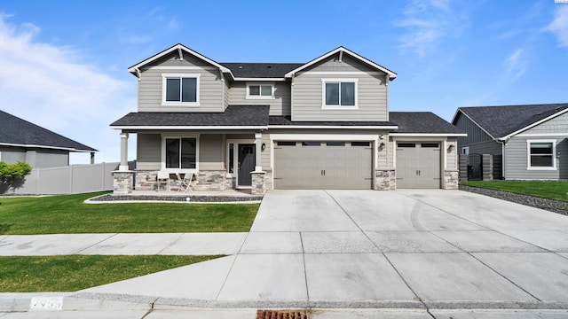2955 S Kellogg St, Kennewick, WA 99338 - craftsman inspired home featuring covered porch, driveway, stone siding, and roof with shingles