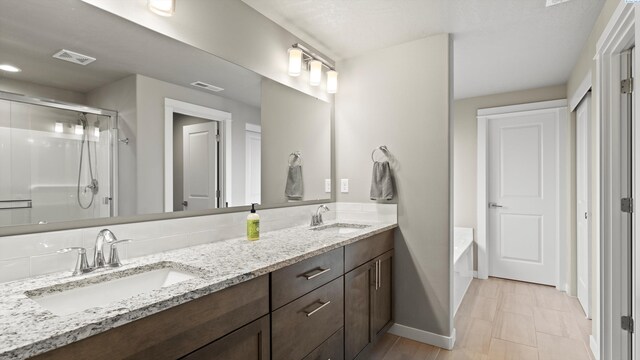 2955 S Kellogg St, Kennewick, WA 99338 - full bath featuring baseboards, a shower stall, double vanity, and a bath