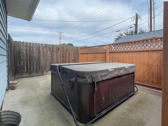 703 W Octave St, Pasco, WA 99301 - fenced backyard with a hot tub and a patio area
