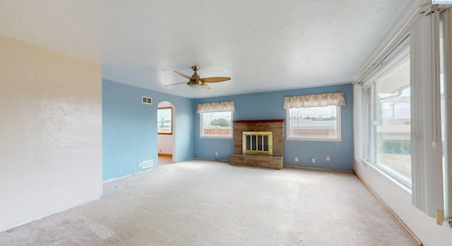 703 W Octave St, Pasco, WA 99301 - unfurnished living room with carpet flooring, a glass covered fireplace, and plenty of natural light