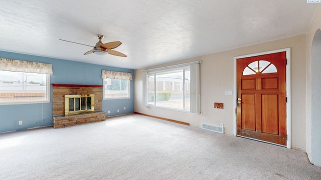 703 W Octave St, Pasco, WA 99301 - carpeted entrance foyer featuring ceiling fan, healthy amount of natural light, and a glass covered fireplace