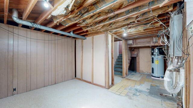 703 W Octave St, Pasco, WA 99301 - unfinished below grade area with hybrid water heater, stairs, and wood walls