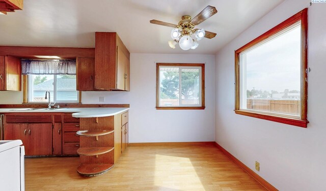 703 W Octave St, Pasco, WA 99301 - kitchen featuring light wood-style flooring, light countertops, a ceiling fan, open shelves, and range