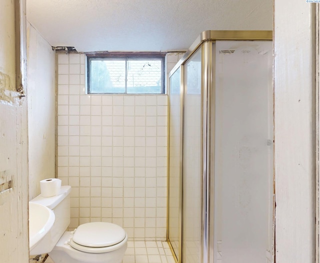 703 W Octave St, Pasco, WA 99301 - bathroom featuring a stall shower and a textured ceiling