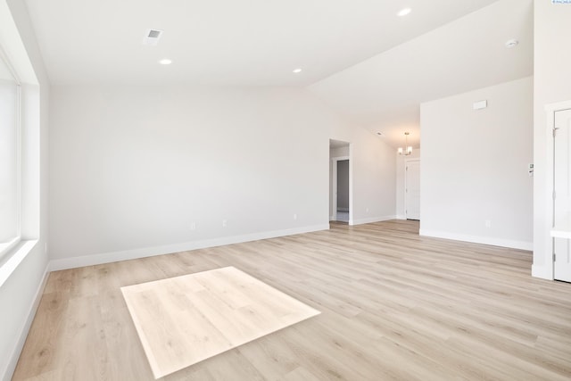 6563 W 30th Pl, Kennewick, WA 99338 - spare room with a chandelier, baseboards, light wood-style floors, and vaulted ceiling