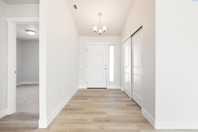 6563 W 30th Pl, Kennewick, WA 99338 - entrance foyer with visible vents, baseboards, light wood-style floors, and a chandelier