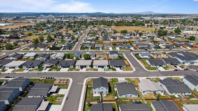 413 Whitefish Ln, Pasco, WA 99301 - aerial overview of property's location featuring a mountainous background and nearby suburban area