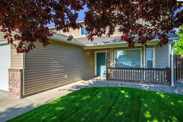 927 N Owen Ave, Pasco, WA 99301 - view of front of property with covered porch, a front yard, an attached garage, and a shingled roof