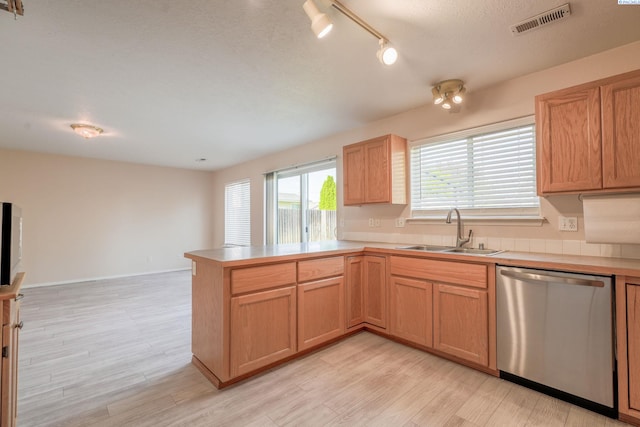 927 N Owen Ave, Pasco, WA 99301 - kitchen featuring stainless steel dishwasher, a sink, a peninsula, and light countertops